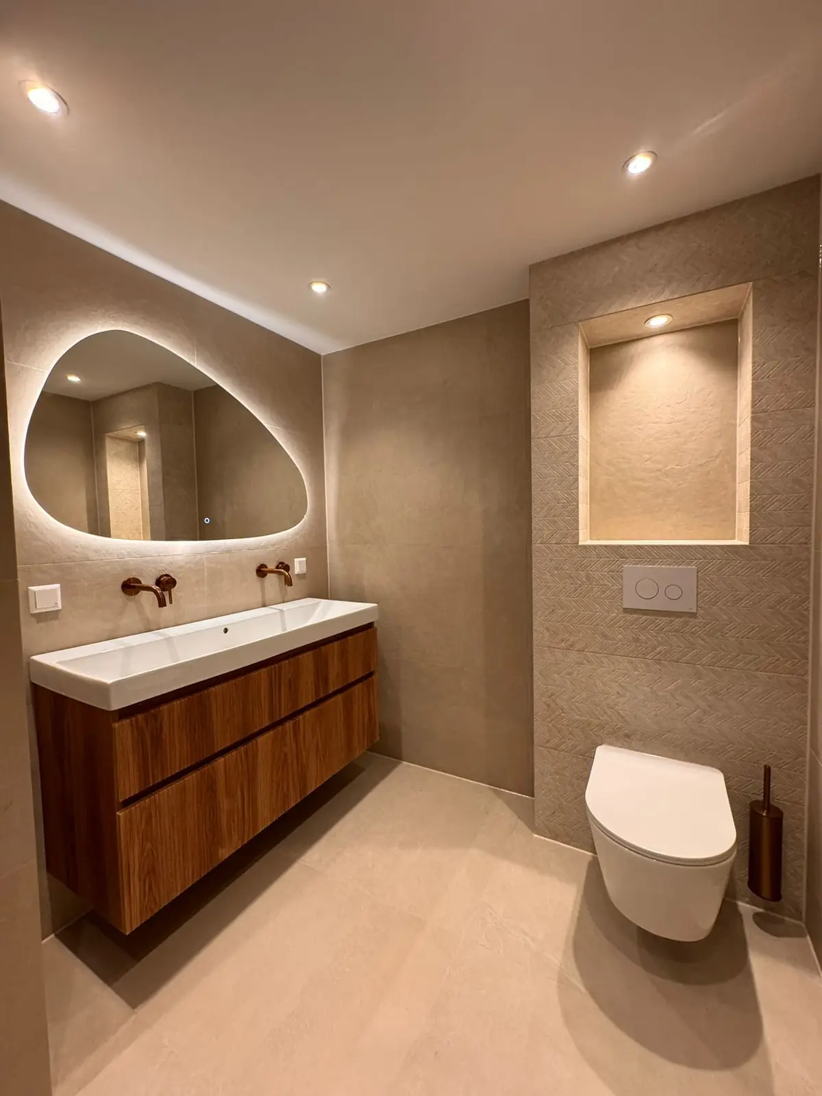 Wastafel en hangend toilet met verlichte spiegel