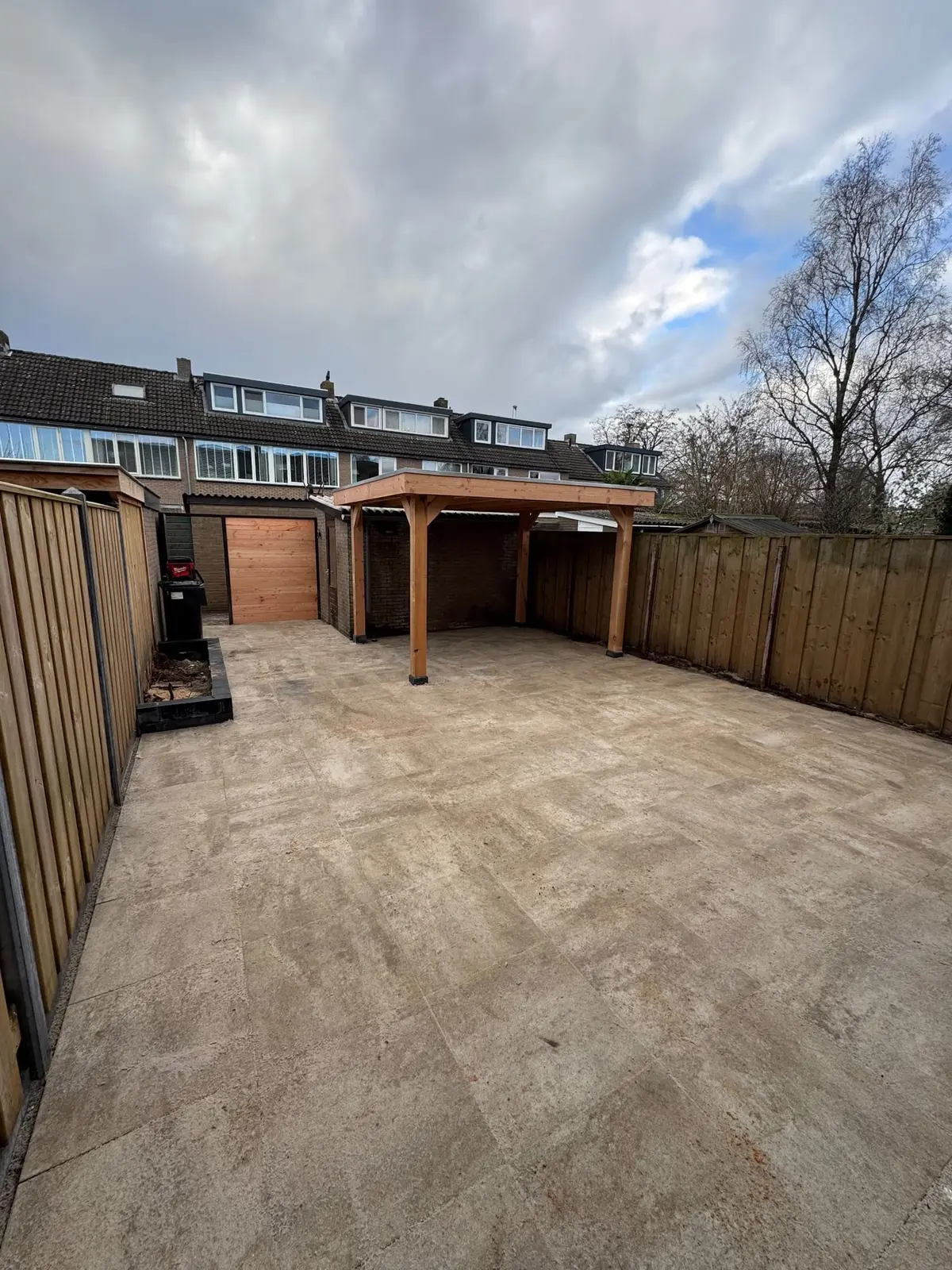 Overzicht van het nieuwe terras en de houten overkapping in Ermelo