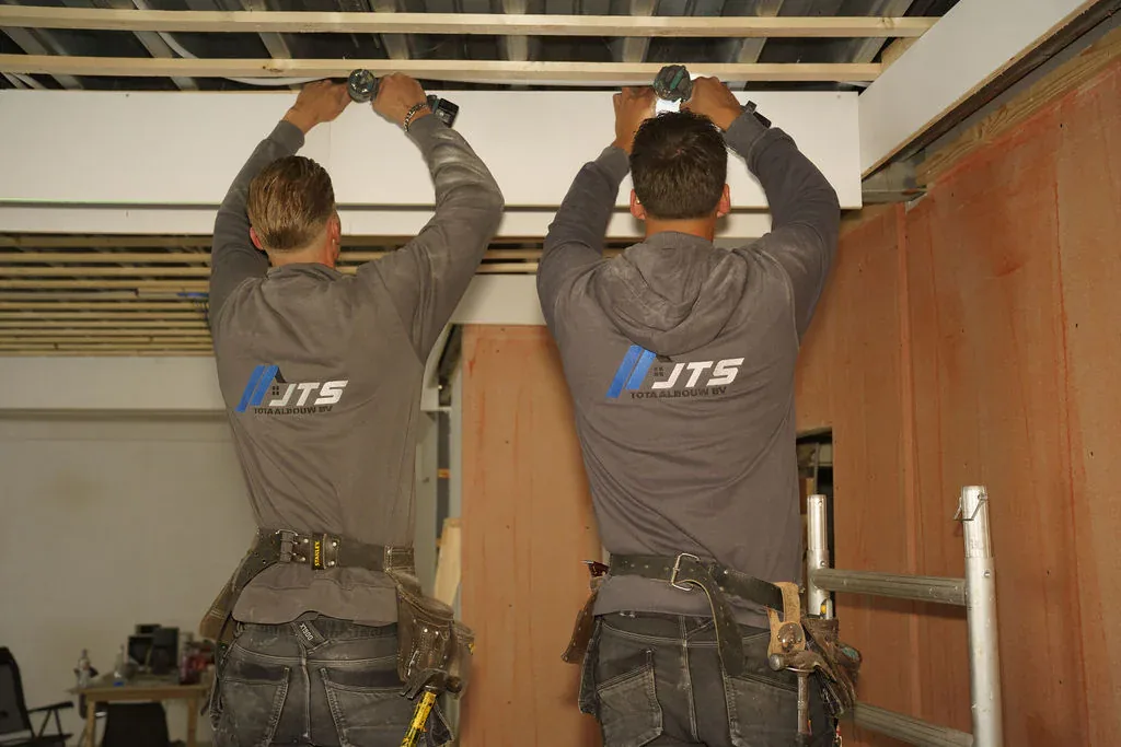 Sem en Jarno monteren samen een plafond tijdens een verbouwing